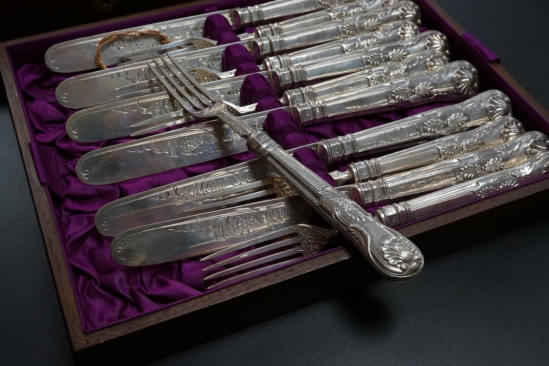 Twelve pairs of Victorian silver King's pattern dessert eaters, by John Gilbert, Birmingham, 1879/1880, loaded handles, in a mahogany canteen.